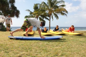 Guests taking surf lessons on poipu beach
